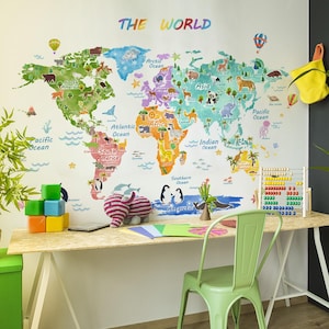 May include: A colorful world map decal with animal illustrations and ocean names is displayed on a white wall. The text "THE WORLD" is above the map. A desk with a green chair, abacus, and toys is in front of the map.