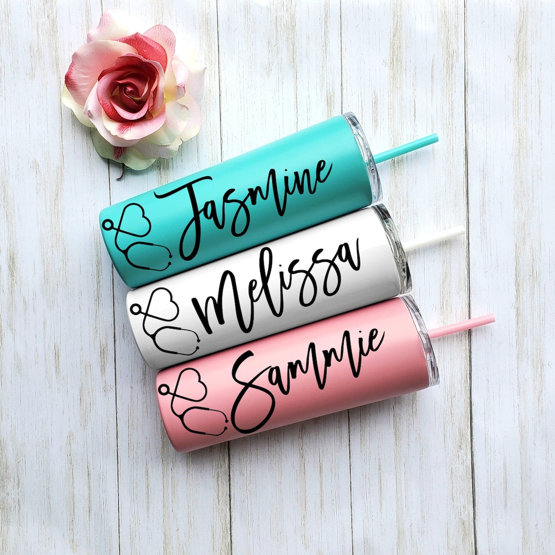 Lidded, insulated cups in three colors with a stethoscope and name in vinyl