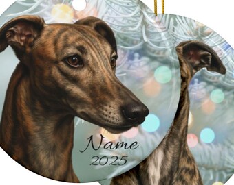 Op de afbeelding: Ronde keramische kerstversiering met een gedetailleerd portret van een gestroomde windhond. Het ornament heeft een gouden ophangkoord. De tekst "Name 2025" is op het ornament gedrukt. De achtergrond heeft een zacht, wazig effect met bokeh-lichten.