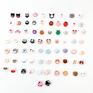May include: A collection of 40 colorful phone charms featuring various cute cartoon characters, including animals, food, and other whimsical designs. The charms are made of silicone and are perfect for adding a touch of personality to your phone case.