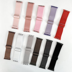 Op de afbeelding: Assortiment van 10 kleurrijke elastische Apple Watch-bandjes. De bandjes zijn gemaakt van een zacht, rekbaar materiaal en zijn verkrijgbaar in verschillende kleuren, waaronder roze, bruin, grijs, zwart en rood.