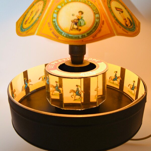 Replica of Emile Reynaud's Praxinoscope with lamp and ten strips to animate