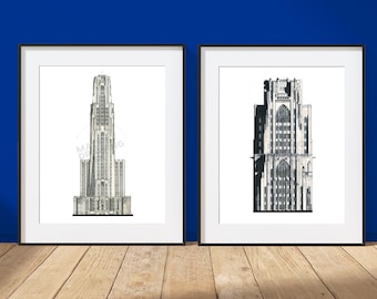 May include: Two framed wall art prints featuring black and white architectural line drawings of tall gothic-style buildings. The left print shows a slender tower, while the right print depicts a wider structure with intricate window details.