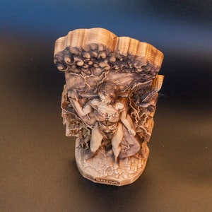 May include: A wooden sculpture of a person standing in a tree, with the text "Matisse" at the bottom.