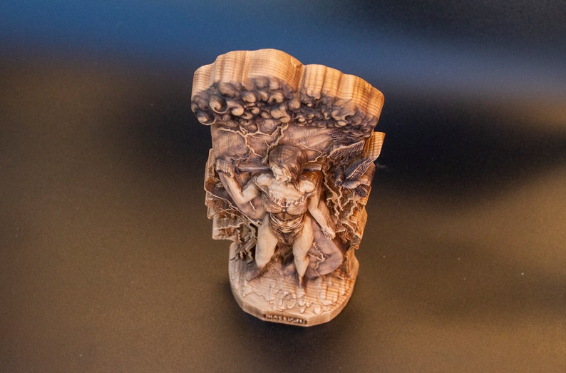 May include: A wooden sculpture of a person standing in a tree, with the text "Matisse" at the bottom.