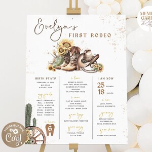 May include: A white milestone birthday sign titled Evelyn's First Rodeo featuring watercolor illustrations of sunflowers, cowboy boots, and a hat. The board displays birth stats, current weight of 25 pounds, height of 18 inches, and personal facts.