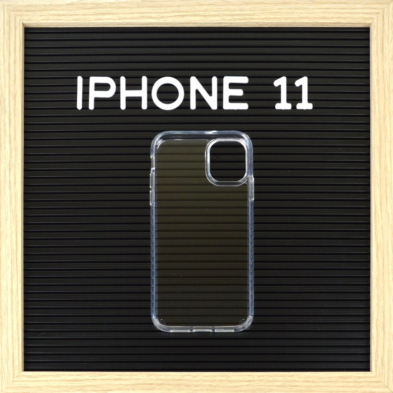 May include: Clear iPhone 11 case on a black background with the text "IPHONE 11" in white block letters. The case is transparent and has a protective design. The background is a textured, dark surface.