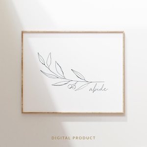 Op de afbeelding: Een ingelijste print met een minimalistische botanische illustratie. Een zwarte lijntekening van een bladrijke tak met olijven en het woord "abide" in script is gecentreerd op een witte achtergrond. De lijst heeft een lichte houtkleur.