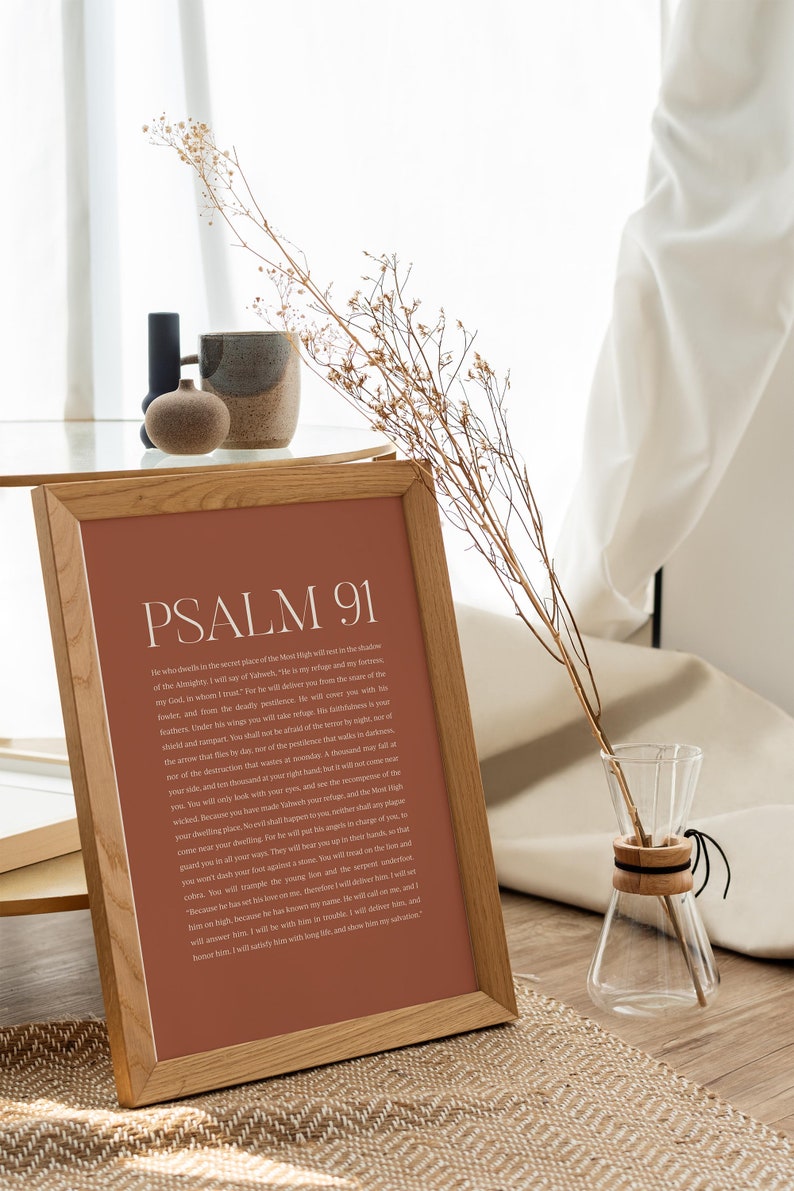 May include: A framed print with a brown background and white text. The text is a passage from Psalm 91 of the Bible. The frame is made of wood and has a natural finish.