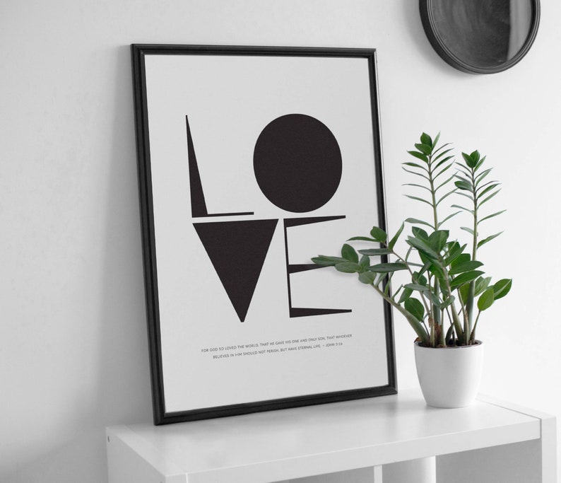 May include: Black and white typography print with the word "LOVE" in bold, geometric shapes. The print includes a quote from John 3:16: "For God so loved the world, that he gave his one and only Son, that whoever believes in him shall not perish but have eternal life."