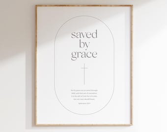 May include: A framed print with the words "saved by grace" in a light gray font, centered within a light gray oval. A cross is below the text. The bottom of the print reads "DIGITAL DOWNLOAD".