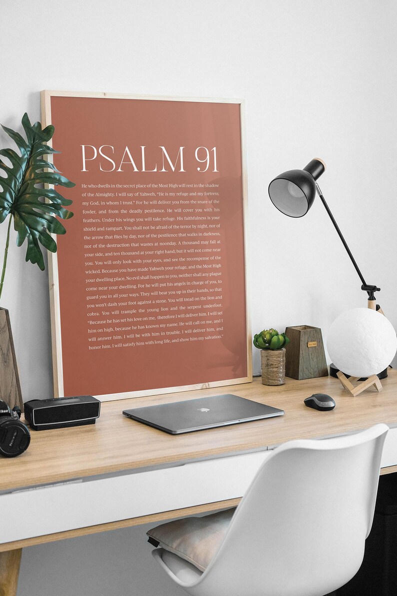 May include: A printable wall art poster with a brown background and white text. The poster features the text "PSALM 91" in a large font at the top and a passage of scripture from the Bible below.