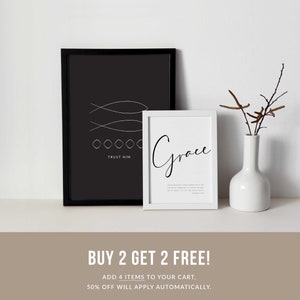 May include: Two framed prints with black frames and white text. The first print has a black background with white fish and the text "TRUST HIM". The second print has a white background with the text "Grace". The prints are on a shelf with a white vase and brown branches.