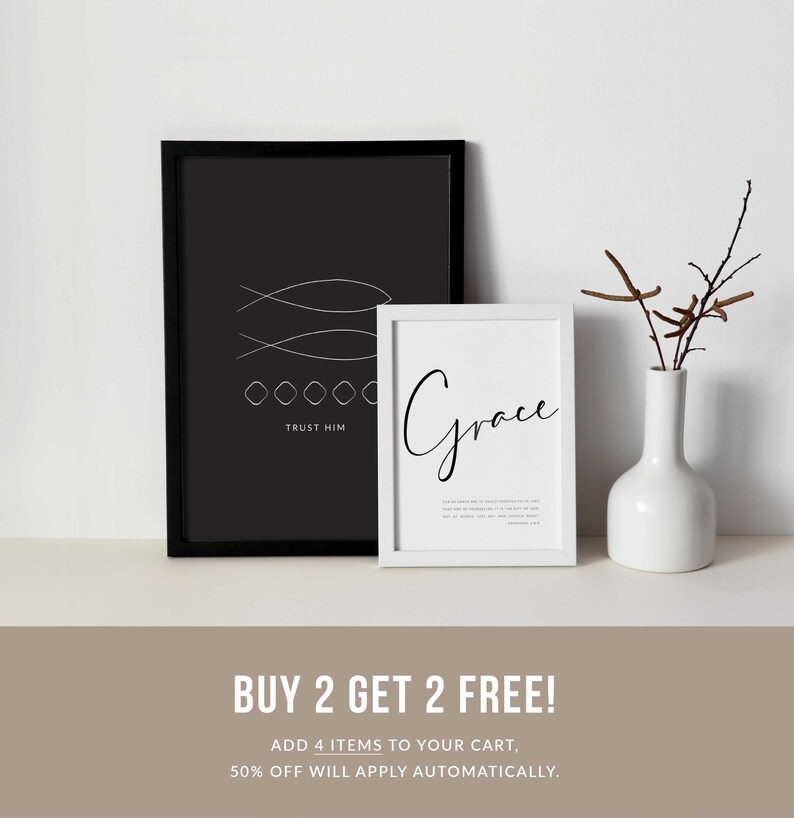 May include: Two framed prints with black frames and white text. The first print has a black background with white fish and the text "TRUST HIM". The second print has a white background with the text "Grace". The prints are on a shelf with a white vase and brown branches.