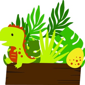 May include: A green dinosaur with red stripes sits in a wooden box with green tropical leaves and a yellow egg with red spots.