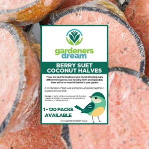 May include: A close-up of a pack of berry suet coconut halves for feeding birds. The pack is pink and white with a bluebird illustration. The text on the pack reads "gardeners dream berry suet coconut halves 1-120 packs available".
