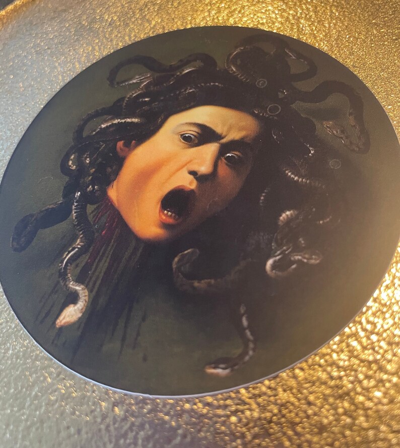 Puede incluir: Un primer plano de una pintura que representa a Medusa, una figura mitol&oacute;gica griega con serpientes por cabello, con una expresi&oacute;n de horror en su rostro.