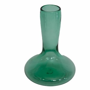May include: A green glass vase with a rounded base and a long, slender neck. The vase has a smooth, glossy finish and is designed to hold flowers. The vase is approximately 8 inches tall.