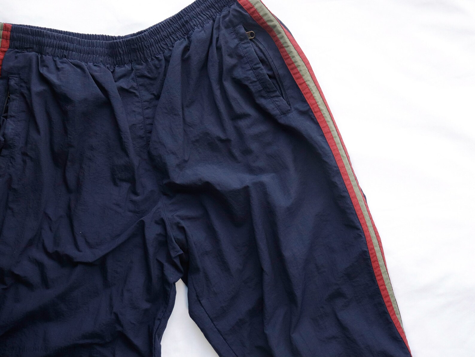 navy blue track pants with red stripe