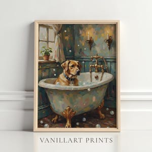 May include: A framed print depicts a golden Labrador Retriever in a vintage bathtub filled with bubbles. The dog wears a collar and sits in a claw-foot tub. The bathroom has a window, sconces, and a faucet. The print is labeled "VANILLART PRINTS".