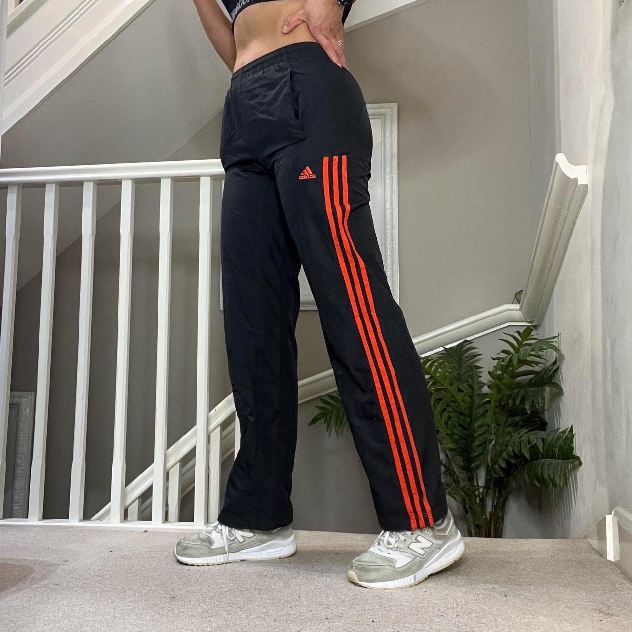black adidas with orange stripes