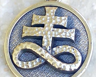 May include: Silver pendant with a textured, hammered finish. The pendant features a stylized cross with an infinity symbol.