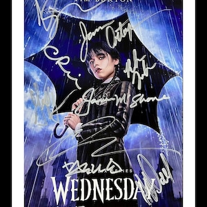 May include: A poster for the Netflix series "Wednesday" featuring Jenna Ortega as Wednesday Addams. The poster is signed by the cast and crew, including Tim Burton, Jenna Ortega, and Gwendoline Christie. The poster is set against a dark blue background with rain falling. The text "From the Imagination of Tim Burton" is at the top of the poster. The text "Wednesday" is in large white letters at the bottom of the poster. The text "Nov 23 | Netflix" is below the title.