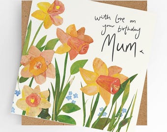 May include: A birthday card with a floral design featuring yellow and orange daffodils. The card reads "with love on your birthday Mum".