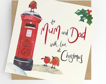 May include: Christmas card with a red postbox and robins. The card reads "to Mum and Dad with love at Christmas". A sprig of holly is in the upper right corner. The card is on a brown envelope.