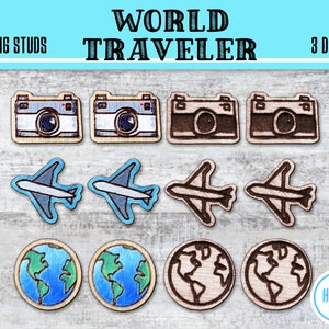 May include: Nine wooden earring studs with three different designs: a camera, an airplane, and a globe. The designs are in various colors, including blue, brown, and white. The text "WORLD TRAVELER" is at the top of the image.