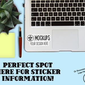 May include: A white laptop computer with a black keyboard and a sticker on the trackpad that says "The Hobby Girl Mockups Your Design Here". The laptop is on a light blue surface with a yellow sticky note, a pen, and a small potted succulent plant.