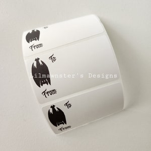 May include: Four white gift tags with a black bat silhouette and the words "From:" and "To:" printed on each tag. The tags are designed for gift giving.
