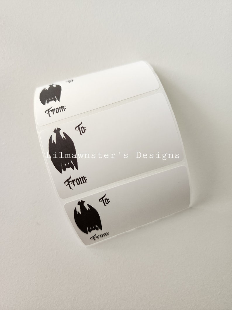 May include: Four white gift tags with a black bat silhouette and the words "From:" and "To:" printed on each tag. The tags are designed for gift giving.