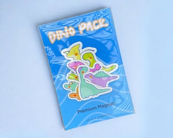 Peut inclure: Un paquet d'aimants de dinosaures colorés avec le texte "Dino Pack" et "Premium Magnets".