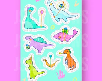 Peut inclure: Un ensemble d'autocollants de dinosaures colorés avec des chapeaux de fête, des ballons et des cadeaux. Les autocollants sont sur un fond bleu clair avec le texte "visit us at jsrainbows.ca".