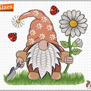 May include: Embroidered design of a gnome holding a daisy and a small shovel. The gnome is wearing a pink hat with white flowers and has a white beard. There are two red ladybugs in the background.