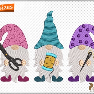 May include: Three gnomes with different colored hats and accessories. The gnome on the left has a pink hat with hearts, is holding scissors, and has maroon shoes. The gnome in the middle has a blue hat and is holding a spool of thread. The gnome on the right has a purple hat with polka dots, is holding a needle and thread, and has purple shoes. The gnomes are all wearing white beards and have white bodies.