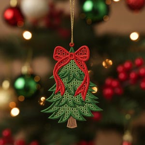 May include: Embroidered Christmas tree ornament with a red bow. The green tree has a detailed openwork design, and the red bow adds a festive touch. The ornament hangs from a gold string, perfect for holiday decor.