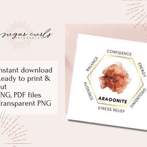 May include: Aragonite crystal with a gold hexagonal frame and text that reads "Aragonite" and "Stress Relief". The frame also has the words "Balance", "Strength", "Confidence", "Energy", and "Grounding" around the crystal.