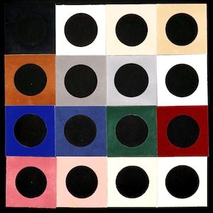 May include: A collection of 16 small, square, fabric-covered boxes with a circular cutout in the center. The boxes are arranged in a 4x4 grid and come in a variety of colors, including black, white, brown, gray, blue, green, red, and pink.