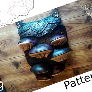 May include: A leather craft pattern for a mushroom-shaped pouch with a teal and purple design. The pattern is laid out on a wooden surface. The text "Pattern" is visible in the lower right corner of the image.