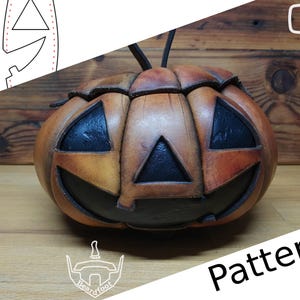 May include: A leather pumpkin with a carved jack-o'-lantern face. The pumpkin is brown and orange with black details. The image includes the text "Pattern".