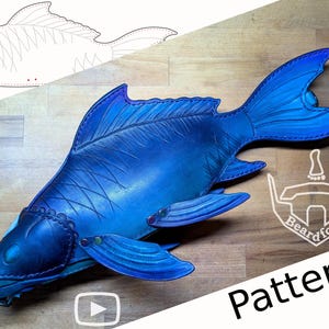 May include: A handcrafted, blue leather fish with detailed fins and scales. The fish is a pattern, with a sketch of the fish above it. The word "Pattern" is written in black text. A logo is in the bottom right corner.