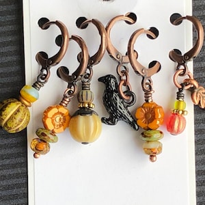 Crow Calls, a set of six removable stitch markers for knitting and crochet.