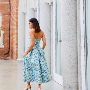 Our model is wearing a modern and elegant floral sky-blue dress, suitable for various special occasions such as graduations and weddings.