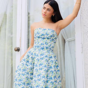 You have an invitation to a wedding or graduation party. For this occasion, we present to you this beautiful strapless dress in blue with a lovely floral design.