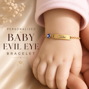 May include: A gold baby bracelet featuring an evil eye charm and a nameplate engraved with the name "Talia". The bracelet is on a baby's wrist, with the text "PERSONALIZED BABY EVIL EYE BRACELET" in the background.
