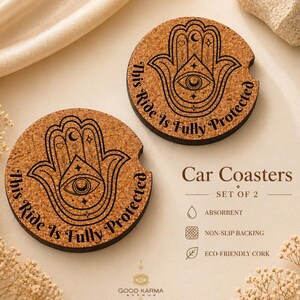 May include: Two round car coasters made of cork, featuring a black Hamsa hand design with an eye and the text "This Ride Is Fully Protected." The coasters are absorbent, have non-slip backing, and are made of eco-friendly cork.