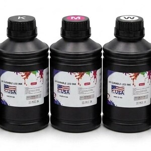 May include: Five black plastic bottles containing UV curable LED ink, each topped with a colored cap labeled C, K, M, W, or Y. The white labels feature a colorful paint splash graphic, the text UV CURABLE LED INK, and a small USA flag icon.
