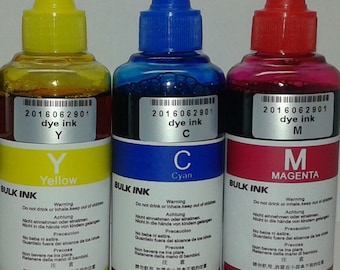 May include: Three bottles of dye ink in yellow, cyan, and magenta colors. Each bottle has a colored cap and a label with the text "BULK INK" and warning information. The bottles are labeled with the letters "Y", "C", and "M".
